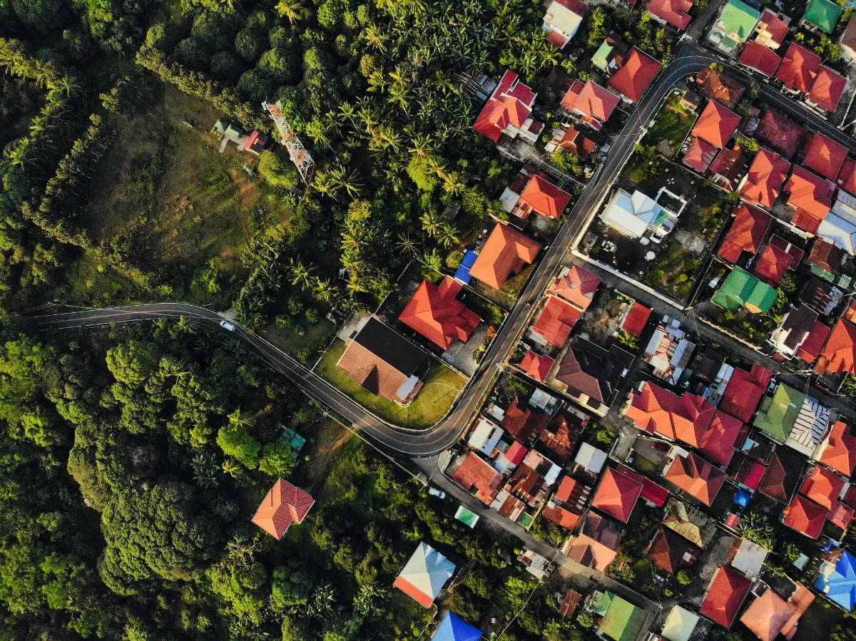 aerial image done shot of colorful buildings surrounded by trees higlighting GIS in real estate