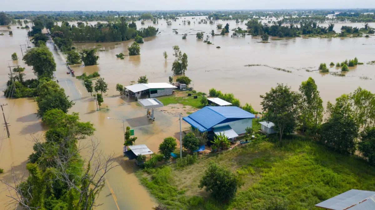 aerial top view of flooded rice paddies village requiring GIS in disaster response