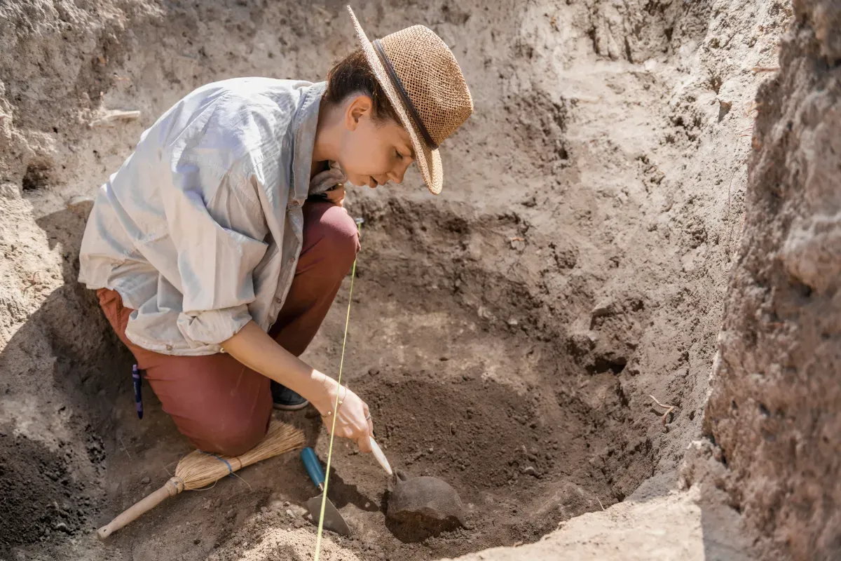 GIS in archaeology with archaeologist uncovering artifacts and remains