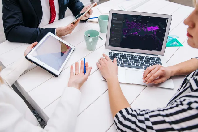 A desk of devices in use at GIS People