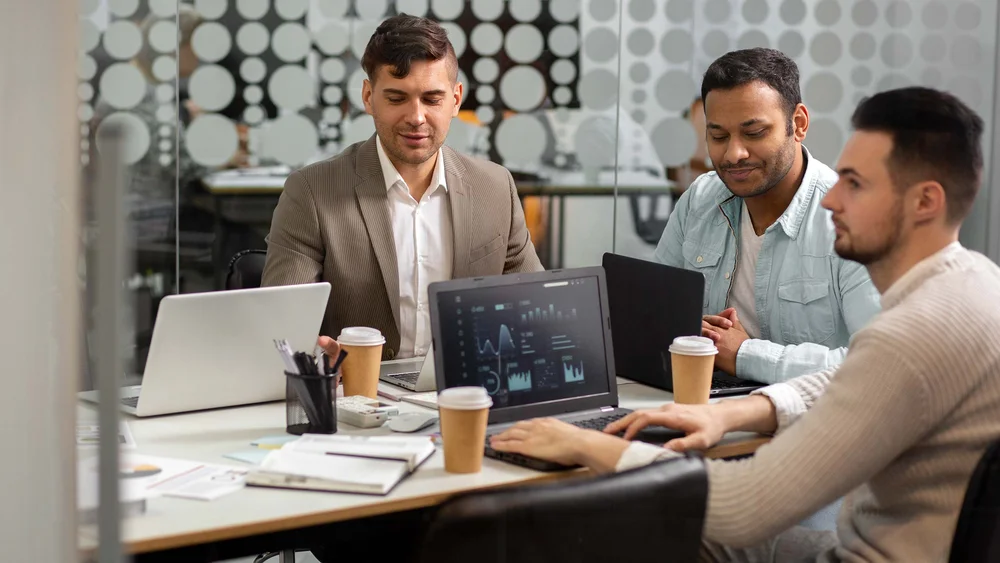 A group of software developers looking at a screen