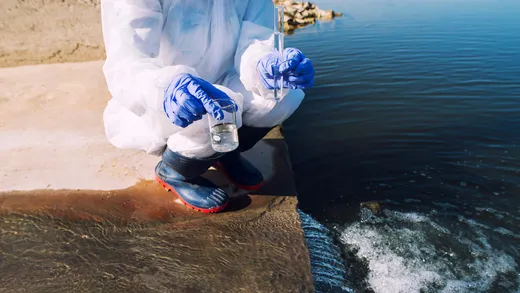 An ecologist taking water samples to check pollution levels