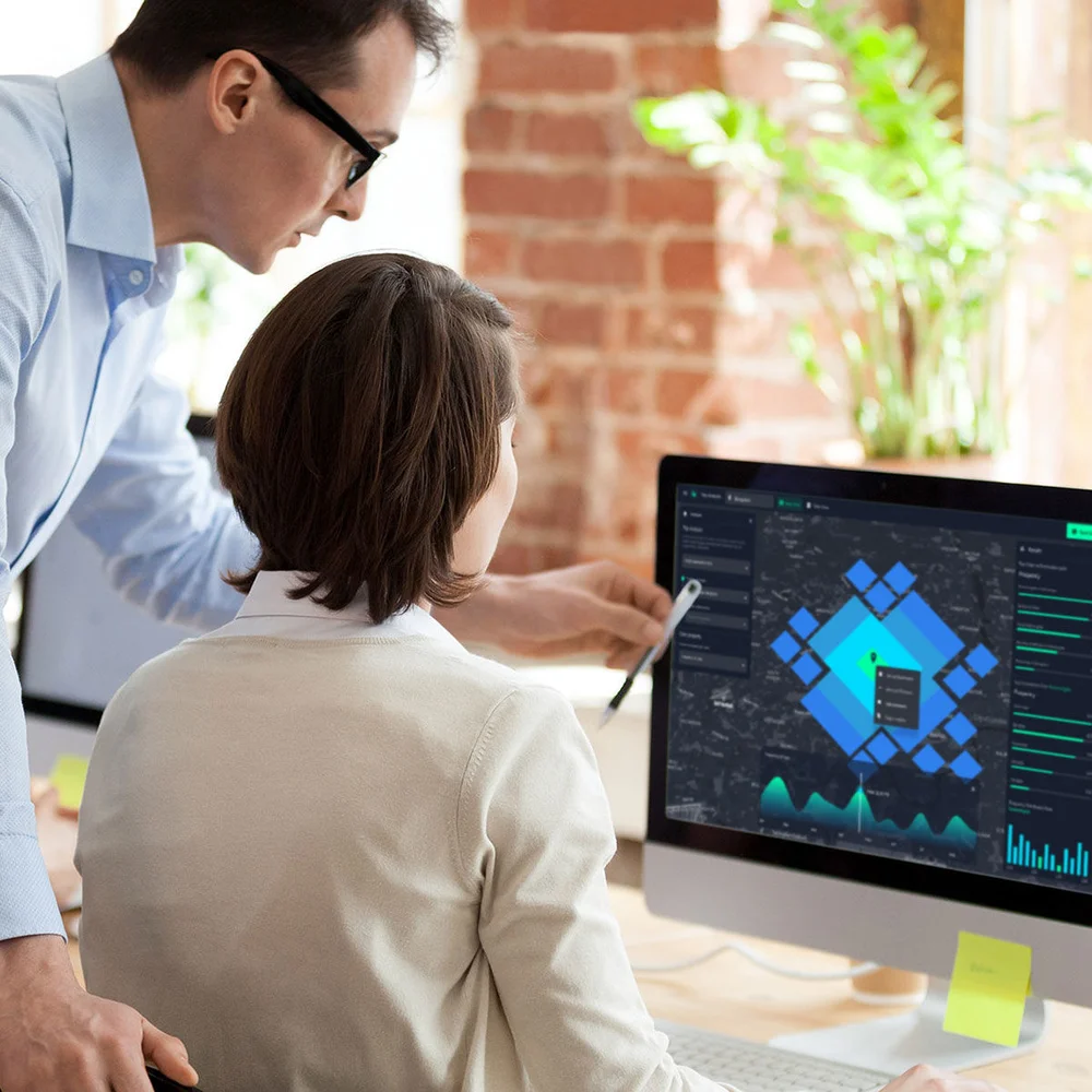 GIS specialists reviewing spatial analytics on screen