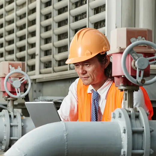 A worker reading utility instructions on a tablet
