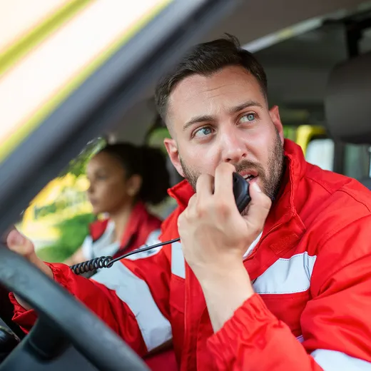 A paramedic communicating by radio from an ambulance